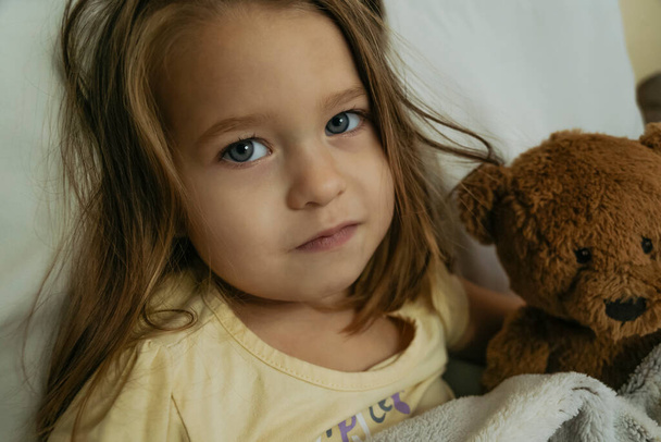 Portrait of sad sick little girl looking to the camera - Foto, immagini
