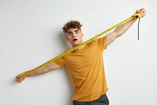 kinky guy grimace measuring tape posing isolated background - Foto, imagen