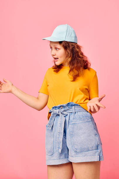 pretty girl in stylish youth clothes hand gesture fun pink background unaltered - Fotografie, Obrázek