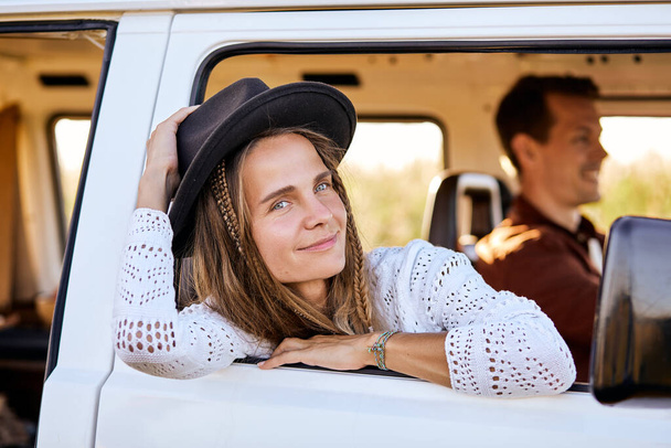 Smiling woman, traveler on road trip with husband,get out of camping van window - Φωτογραφία, εικόνα