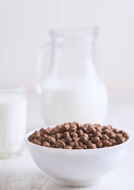 Breakfast: chocolate balls, fresh cows milk, selective focus - Фото, изображение