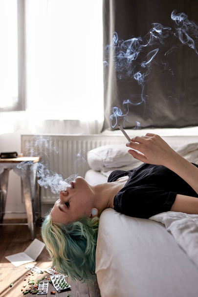 Caucasian woman sad from love, smoking because of stress after breaking with boyfriend - 写真・画像