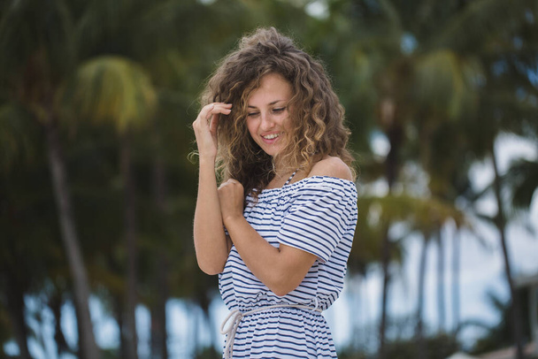 Beautiful girl on a background of palm trees. - Valokuva, kuva