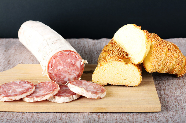 Salami and bread on board - Photo, Image