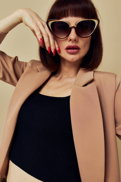 beautiful woman Charm red nails model luxury sunglasses light background - Foto, immagini