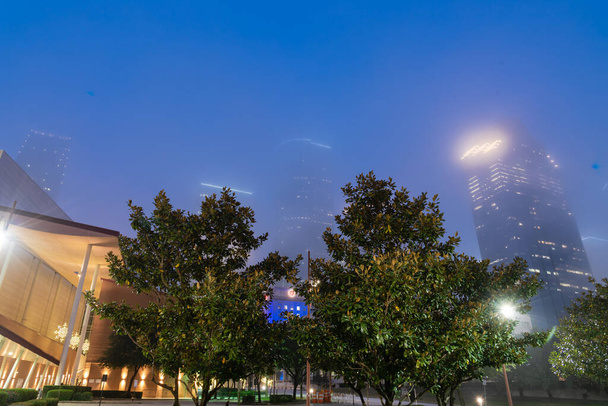 Skyscrapers and high-rise corporate buildings in downtown Houston in foggy mist weather at blue hour - Photo, Image