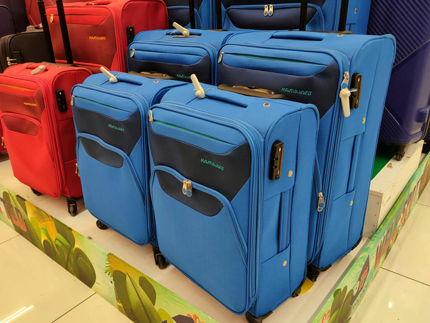 PENANG, MALAYSIA -16 JUNE 2021: Selected focused on various types of travel bags sold in a supermarket. Comes in a variety of designs and colors, as well as marked with a price tag. - Photo, Image