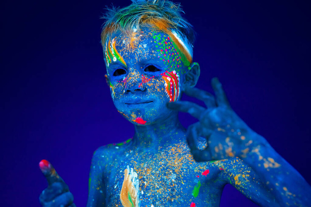 Portrait of a neon baby boy, shows class and super in UV light. - Foto, Imagem
