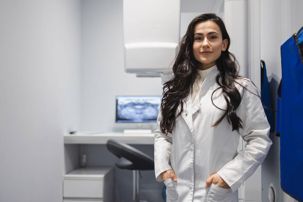 Porträt einer Ärztin im CT-Raum. Frau neben dem Tomographen - Foto, Bild