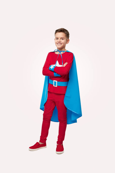 Smiling superhero boy in costume in studio - Photo, Image
