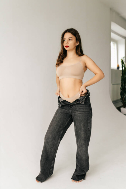 Young model girl in studio posing in top and pants - Foto, Imagen