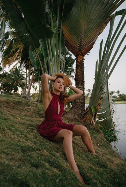 beautiful dancer girl on a walk in a golf club on a tropical island in the Dominican Republic, moves gracefully, salsa and bachata - 写真・画像