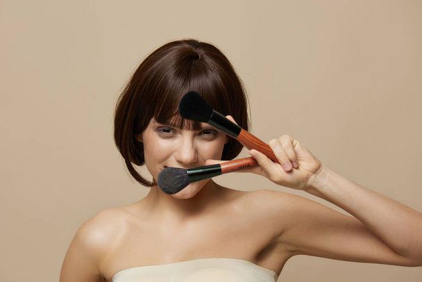 beautiful woman makeup brushes in hand model makeup posing close-up Lifestyle - Fotó, kép