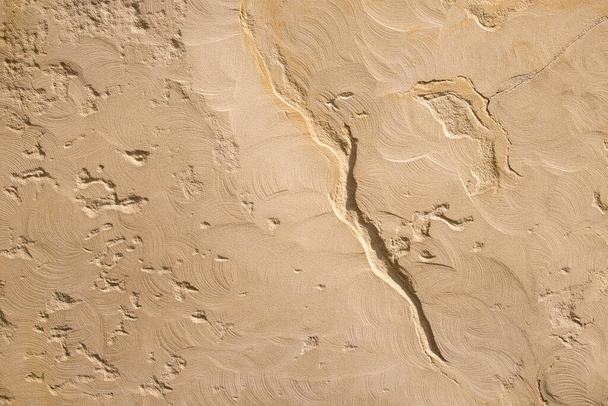 Beige sandy plaster texture with scratches and cracks. Patterned background. - Фото, изображение