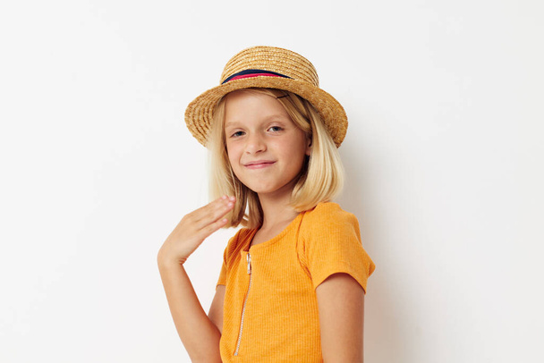cheerful little girl wearing a hat fashion posing light background - Foto, afbeelding