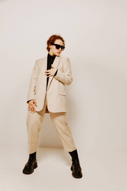 cheerful woman in a suit sunglasses gestures with his hands emotions isolated backgrounds unaltered - Photo, Image