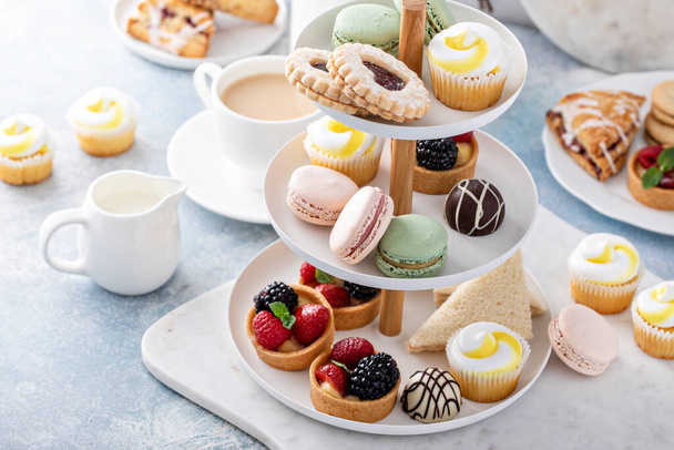 Spring or summer dessert table, three tiered tray with desserts - Фото, зображення