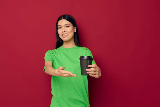 Portrait Asian beautiful young woman posing in a green t-shirt disposable black glasses studio model unaltered - Foto, immagini