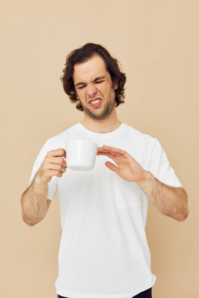 Attractive man with a white mug in his hands emotions posing isolated background - Fotoğraf, Görsel