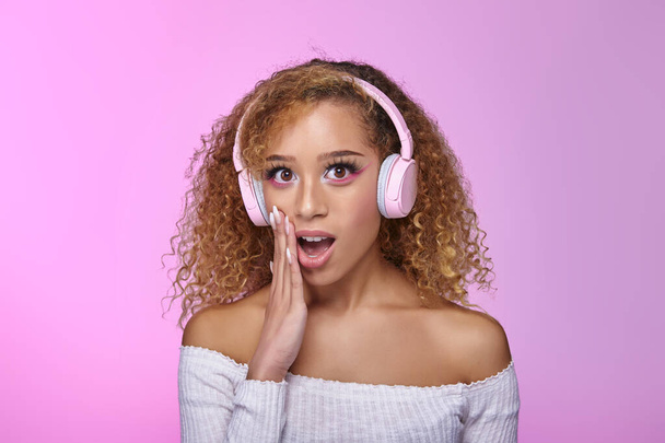 Amazed black woman listening to music in headphones - Fotografie, Obrázek