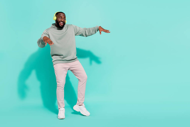 Full length body size view of cheerful attractive guy dancing hip hop moving copy space isolated over shine teal turquoise color background - Foto, Imagen