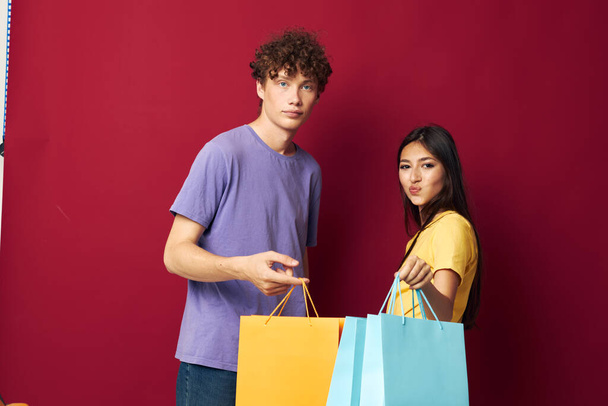 cute young couple shopping bags in hand isolated background unaltered - Fotografie, Obrázek