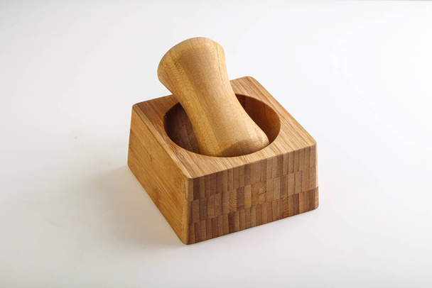 Wooden mortar for kitchen isolated over background - Foto, imagen