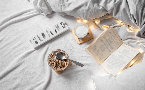Cozy composition with cereal and milk in bed. - Photo, Image