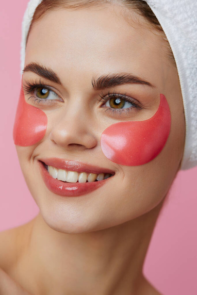 portrait woman pink patches on the face with a towel on the head isolated background - Foto, Bild