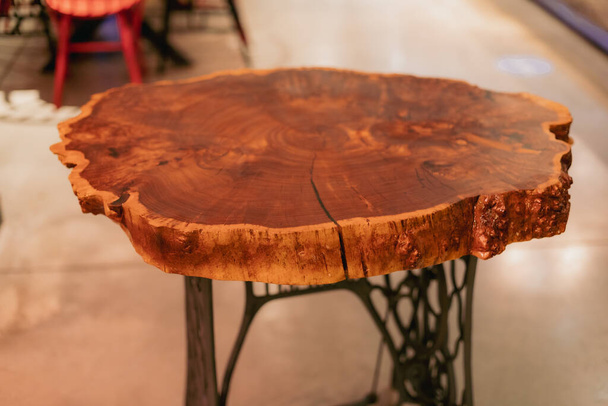 Handmade epoxy resin round wood table. Reclaimed wood furniture and live edge table made from fallen trees - Foto, afbeelding