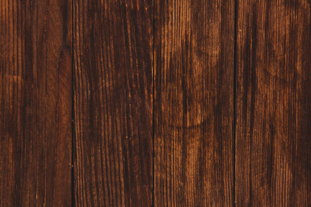 Textura de fondo de madera marrón vintage con nudos y agujeros para uñas. Antigua pared de madera pintada. Fondo abstracto marrón. Tableros horizontales oscuros de madera vintage. Vista frontal con espacio de copia - Foto, imagen