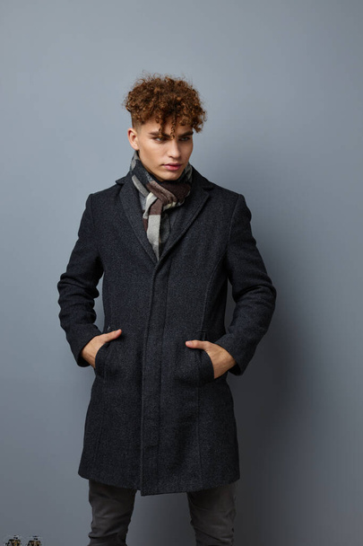 handsome young man Black coat posing fashion isolated background - Foto, Imagen