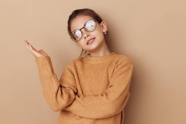 cute girl with glasses emotions gesture hands beige background - Foto, afbeelding
