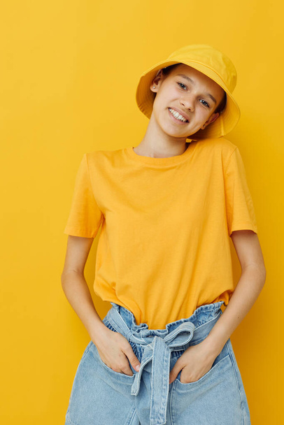 attractive woman in a yellow hat Youth style casual wear yellow background - Fotó, kép