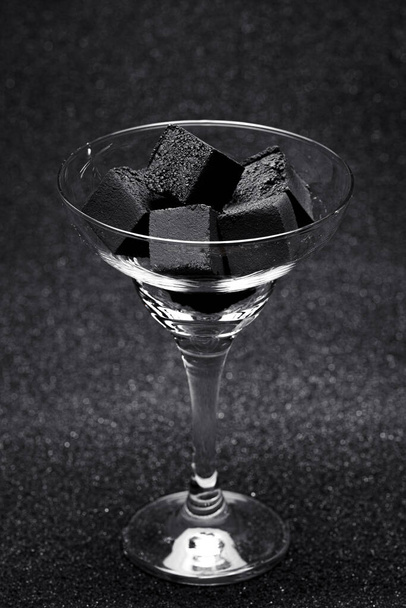 Coal for a hookah on a gray background. - Foto, Imagen