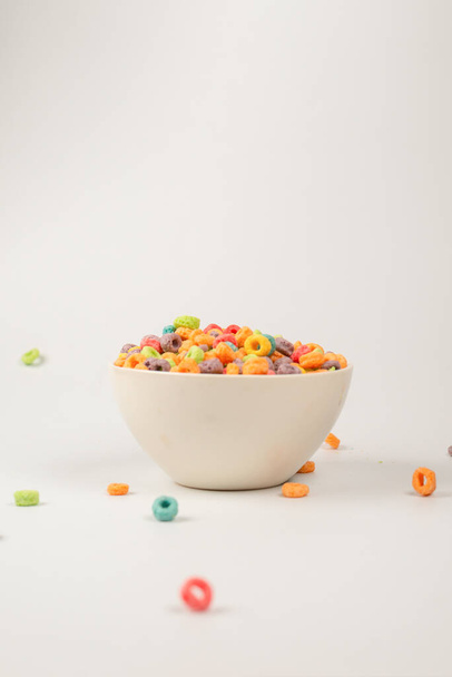 Colorful cereal box for morning breakfast. Corn flakes falling to the white bowl. Motion. Copyspace. - Foto, immagini