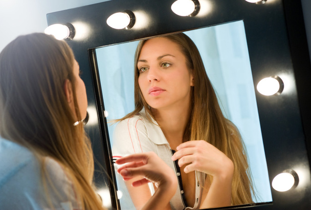 Jeune femme s'admirant dans le miroir
 - Photo, image