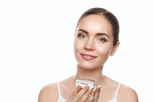 Beautiful Woman holdinging  moisturizing cream . Cosmetics. female with clean  skin. Skin Care. Facial treatment. Cosmetology, beauty and spa - Fotoğraf, Görsel