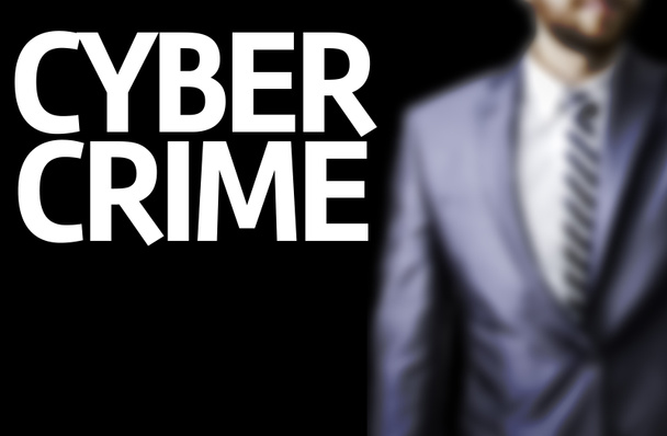 Cyber Crime written on a board with a business man - Photo, Image