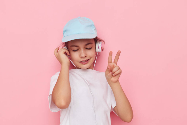 cute girl headphones in a white t-shirt and a cap Lifestyle unaltered - Fotoğraf, Görsel