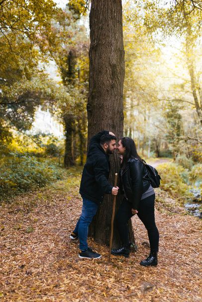Couple in love touching their noses during an excursion in the forest - Photo, image