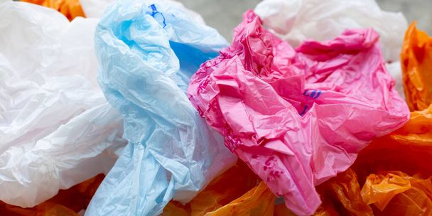 Colorful plastic bags on cement floor - Foto, afbeelding