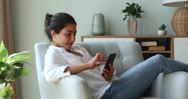Indian woman holds cellphone got unbelievable fantastic news feels happy - Felvétel, videó