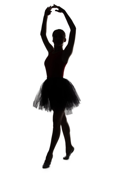 Silhouette táncos lány kezeket fel - Fotó, kép