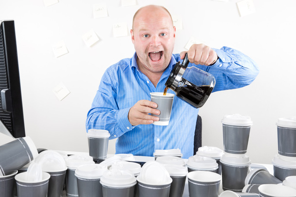 Happy businessman drinks way too much coffee - Photo, Image