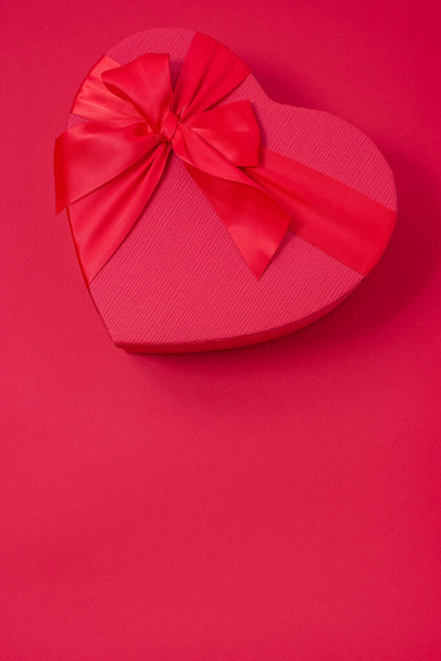 Valentine's day gift on red background - red heart box with bow - Photo, Image