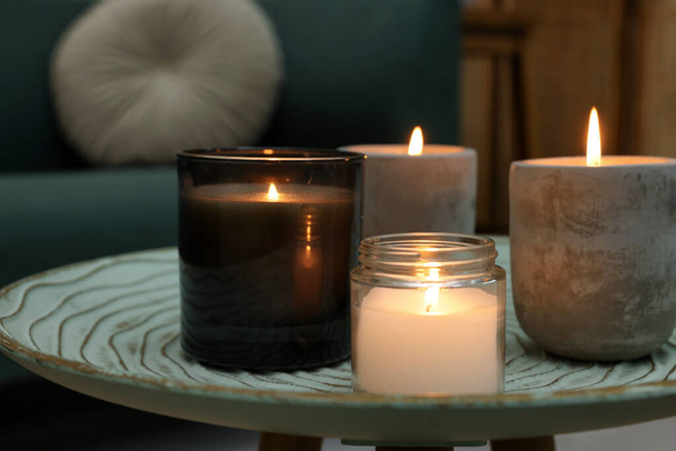Lit candles on table in living room - Φωτογραφία, εικόνα