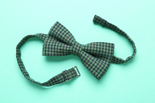 Stylish gingham bow tie on light green background, top view - Foto, Imagen
