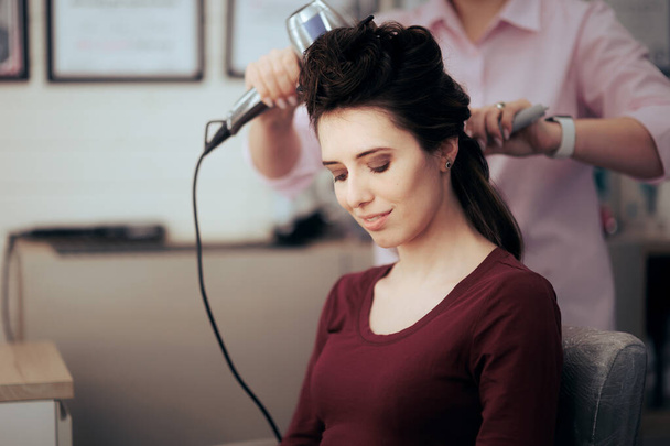 Woman Sitting in Hair Salon Having Her Hair Professionally Done - Valokuva, kuva