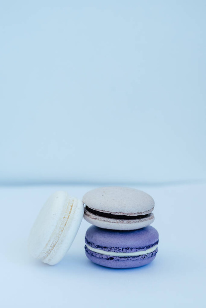 purple gray and white macarons on a white background fresh and delicious dessert. High quality photo - Φωτογραφία, εικόνα
